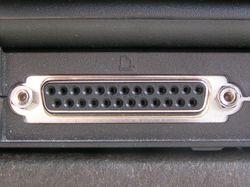 A DB-25 parallel printer port on the back of a laptop.